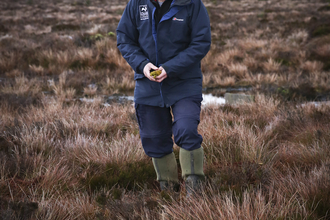 Duncan standing on a wetland