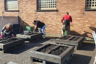 Volunteers planting at the Leigh Community Garden