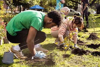 Picture of two volunteers planting trees