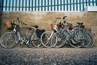 Four bikes leaning against wall