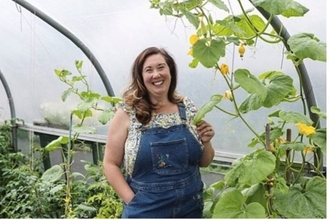 Photo of Victoria Holden, the Director of Northern Lily CIC, gardening in greenhouse.