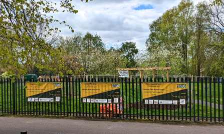 Signs in locally-spoken languages welcome visitors to the community garden