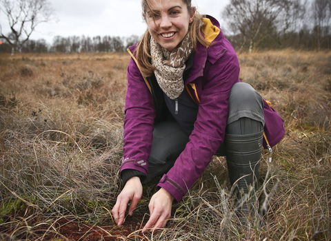 Elspeth holding soil in a wetland