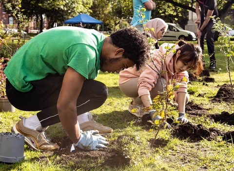 Picture of two volunteers planting trees